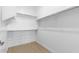 Bright, walk-in closet features wood-look floors and ample shelving space at 4419 N 203Rd Ave, Buckeye, AZ 85396
