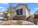 Side exterior view of the home showing stone accents and tasteful landscaping at 4419 N 203Rd Ave, Buckeye, AZ 85396