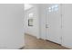 A bright and airy foyer with tile floors, fresh white walls, and a front door at 4419 N 203Rd Ave, Buckeye, AZ 85396