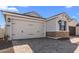 View of the home's garage with attractive stone accents and a paved driveway at 4419 N 203Rd Ave, Buckeye, AZ 85396