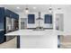 Spacious kitchen features a large island, stainless appliances, and elegant pendant lighting at 4419 N 203Rd Ave, Buckeye, AZ 85396