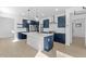 Open concept kitchen with stainless steel appliances, large island, and ample cabinet space at 4419 N 203Rd Ave, Buckeye, AZ 85396