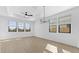 Bright living room featuring wood-look tile floors, recessed ceilings, and large windows at 4419 N 203Rd Ave, Buckeye, AZ 85396