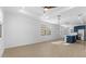 Bright living room and modern kitchen area with wood-look tile floors and recessed lighting at 4419 N 203Rd Ave, Buckeye, AZ 85396