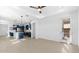 Bright living room showing wood-look tile floors flowing into a modern kitchen with blue cabinets at 4419 N 203Rd Ave, Buckeye, AZ 85396