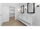 The luxurious main bathroom features dual sinks, mirrors, and a walk-in closet at 4419 N 203Rd Ave, Buckeye, AZ 85396