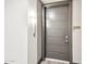 Modern apartment entry with gray door and sleek light fixture at 5250 E Deer Valley Dr # 450, Phoenix, AZ 85054