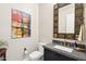 Stylish powder room with a single vanity and decorative mirror at 5250 E Deer Valley Dr # 450, Phoenix, AZ 85054