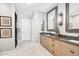 Elegant bathroom with double vanity, large mirrors, and a walk-in shower at 5250 E Deer Valley Dr # 450, Phoenix, AZ 85054