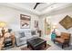 Comfortable sitting area with sofa, ottoman, and ceiling fan at 5250 E Deer Valley Dr # 450, Phoenix, AZ 85054