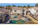Backyard view of pool with rock features and covered patio and lush landscaping offers a relaxing outdoor oasis at 659 S Dodge St, Gilbert, AZ 85233