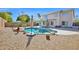 Expansive backyard featuring a sparkling pool, rock accents, lounge chairs, and beautiful patio area for relaxing at 659 S Dodge St, Gilbert, AZ 85233