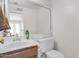 Bathroom featuring a wood vanity, a single sink, a mirror, and a toilet at 659 S Dodge St, Gilbert, AZ 85233