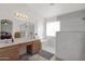 Well-lit bathroom featuring double sinks, ample counter space, and a separate bathtub with marble at 659 S Dodge St, Gilbert, AZ 85233
