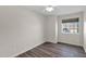 Well-lit bedroom featuring wood-look flooring and a view from the window at 659 S Dodge St, Gilbert, AZ 85233