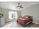 A cozy bedroom features vaulted ceiling, with a ceiling fan, a comfortable bed, and a bright window at 659 S Dodge St, Gilbert, AZ 85233