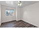 Bright bedroom featuring a ceiling fan, wood-look flooring, and a view from the window at 659 S Dodge St, Gilbert, AZ 85233