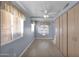 Bright bedroom featuring a ceiling fan, wood-look flooring, and window with wooden blinds at 659 S Dodge St, Gilbert, AZ 85233