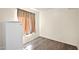 Cozy bedroom with light wood flooring and a small refrigerator in the corner at 659 S Dodge St, Gilbert, AZ 85233