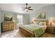 Cozy bedroom with natural light, vaulted ceiling, soft green walls, and stylish decor at 659 S Dodge St, Gilbert, AZ 85233