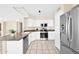 Well-lit kitchen featuring white cabinets, stainless steel appliances and tile flooring at 659 S Dodge St, Gilbert, AZ 85233