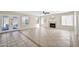 Spacious living room with fireplace, tile floors, ceiling fan and natural light from french doors to patio at 659 S Dodge St, Gilbert, AZ 85233