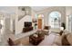 Bright living room showcasing high ceilings, a large window, tile flooring, and a view of the staircase at 659 S Dodge St, Gilbert, AZ 85233