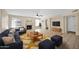 Spacious living room features a fireplace, large windows, tile flooring, and comfortable blue sectional couch at 659 S Dodge St, Gilbert, AZ 85233