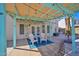 Covered patio has outdoor seating, a ceiling fan, and a view of the landscaped backyard and pool area at 659 S Dodge St, Gilbert, AZ 85233