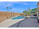 The backyard has a pool, covered patio, lounge area, desert landscaping, and provides relaxation and entertainment space at 659 S Dodge St, Gilbert, AZ 85233