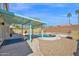 Inviting pool area featuring a covered patio, lush landscaping, and comfortable seating, perfect for outdoor relaxation at 659 S Dodge St, Gilbert, AZ 85233