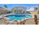 Backyard pool and spa with rock waterfall feature and covered patio perfect for entertaining at 659 S Dodge St, Gilbert, AZ 85233