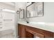 Clean bathroom with wood cabinets and large vanity mirror at 1102 N 5Th St, Buckeye, AZ 85326