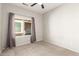 Bright bedroom with large window and grey curtains at 1102 N 5Th St, Buckeye, AZ 85326