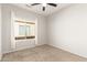 Comfortable bedroom with window and ceiling fan at 1102 N 5Th St, Buckeye, AZ 85326