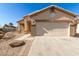 Single-story home with attached garage and desert landscaping at 1102 N 5Th St, Buckeye, AZ 85326
