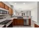 Well-equipped kitchen with stainless steel appliances and wood cabinetry at 1102 N 5Th St, Buckeye, AZ 85326