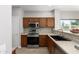 Modern kitchen with stainless steel appliances and wood cabinets at 1102 N 5Th St, Buckeye, AZ 85326