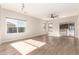 Spacious living room with wood-look flooring and sliding glass door at 1102 N 5Th St, Buckeye, AZ 85326