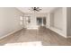 Bright living room with wood-look floors, ceiling fan, and built-in shelving at 1102 N 5Th St, Buckeye, AZ 85326
