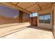 Covered patio with shade screens and access to backyard at 1102 N 5Th St, Buckeye, AZ 85326