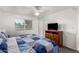 Spacious bedroom featuring a ceiling fan and large window at 11024 W Peoria Ave, Sun City, AZ 85351