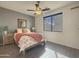 Bedroom with wood flooring, a ceiling fan, and a queen-size bed at 14335 W Country Gables Dr, Surprise, AZ 85379