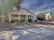 One-story home with landscaped front yard and stone pathway at 14335 W Country Gables Dr, Surprise, AZ 85379