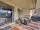 Covered patio with seating area, fire pit table, and access to backyard at 14335 W Country Gables Dr, Surprise, AZ 85379