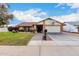 House exterior showcasing a well-maintained lawn, driveway, and basketball hoop at 1449 W Mohawk Ln, Phoenix, AZ 85027