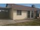 Exterior view showcasing the well-maintained siding, updated windows, and attached covered space, offering a welcoming appeal at 1449 W Mohawk Ln, Phoenix, AZ 85027