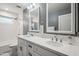 Bathroom with double vanity, white cabinets, and updated fixtures at 1545 W Berridge Ln, Phoenix, AZ 85015