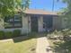 Brick house with dark brown front door, landscaping, and walkway at 1545 W Berridge Ln, Phoenix, AZ 85015