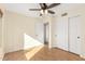 Bedroom with laminate wood flooring, ceiling fan and double door closet at 1574 E Kent Ave, Chandler, AZ 85225